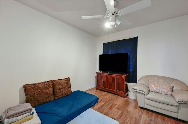 living room featuring ceiling fan and light hardwood / wood-style floors