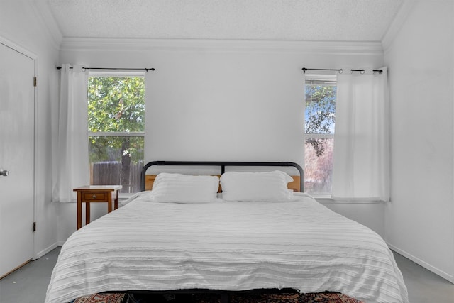 bedroom featuring ornamental molding, a textured ceiling, and vaulted ceiling