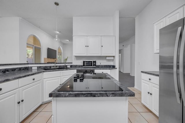 kitchen featuring white cabinets, appliances with stainless steel finishes, and a kitchen island