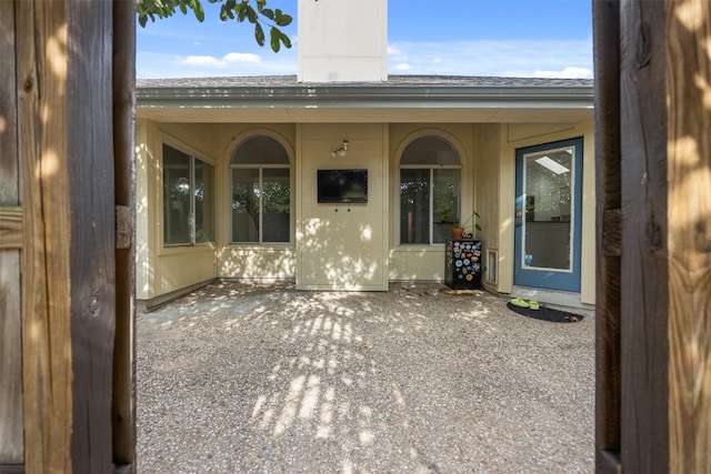 doorway to property with a patio