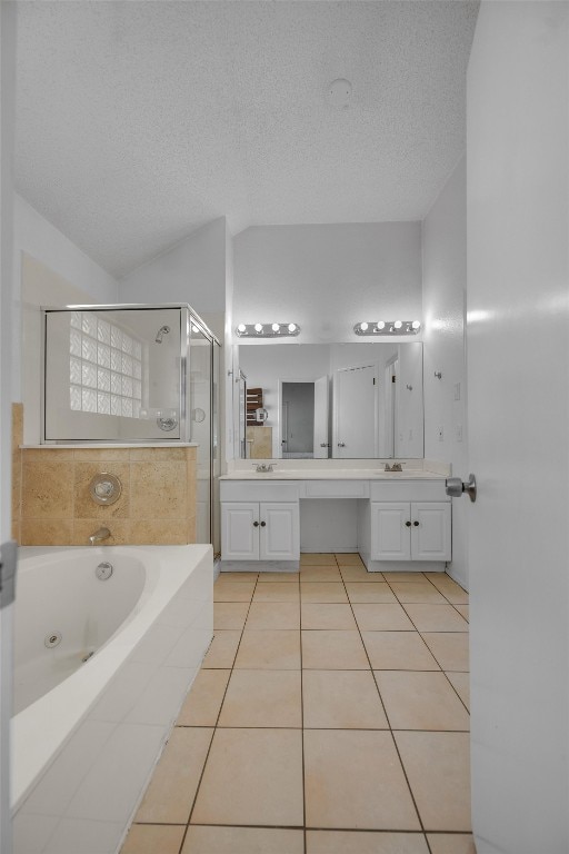 bathroom with tile patterned floors, vanity, and a textured ceiling