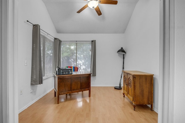 home office featuring a textured ceiling, ceiling fan, light hardwood / wood-style floors, and lofted ceiling