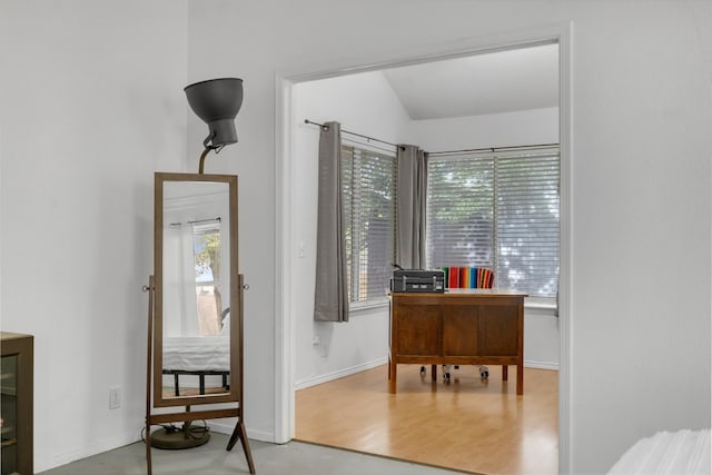 office area with hardwood / wood-style flooring and vaulted ceiling