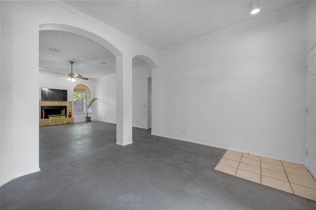 unfurnished living room with crown molding, ceiling fan, and a textured ceiling