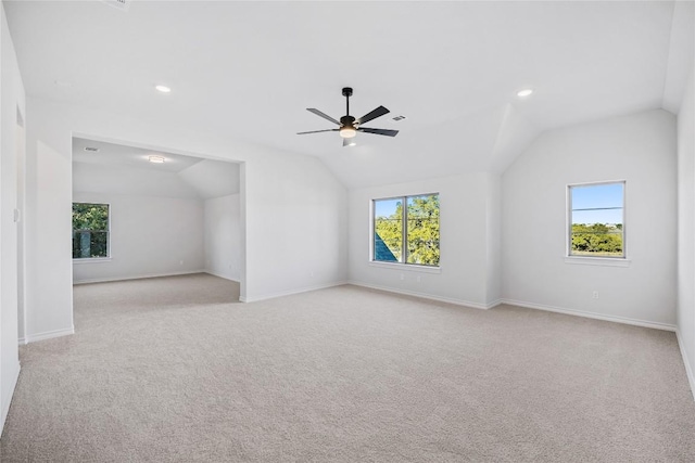 bonus room featuring light colored carpet, ceiling fan, vaulted ceiling, and a wealth of natural light