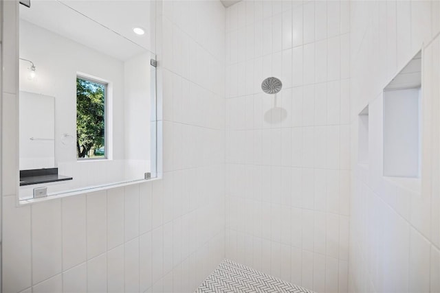 bathroom with tiled shower