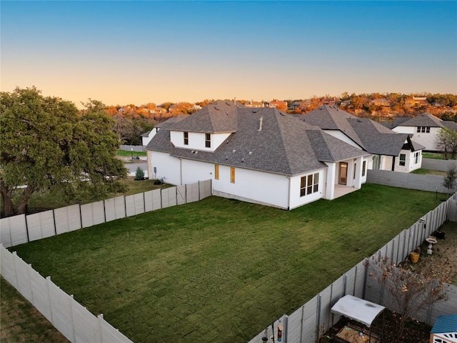 view of yard at dusk