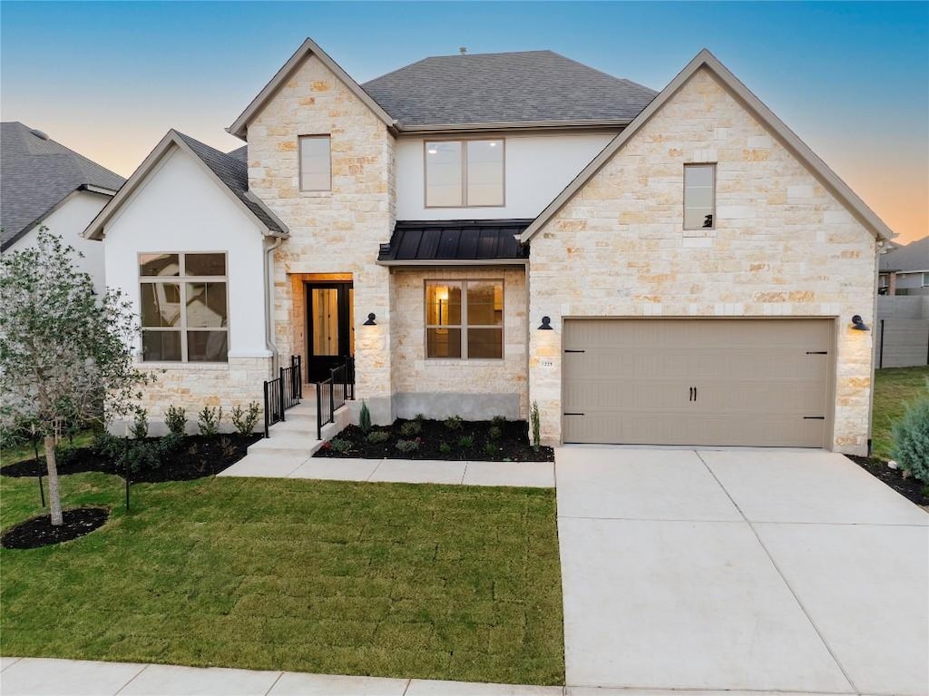1225 River Trce, Georgetown, TX 78628 - view of front of property featuring an attached garage, a yard, driveway, a shingled roof, and a standing seam roof