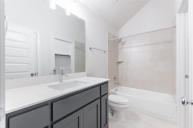 full bathroom with vanity, tiled shower / bath combo, lofted ceiling, and toilet