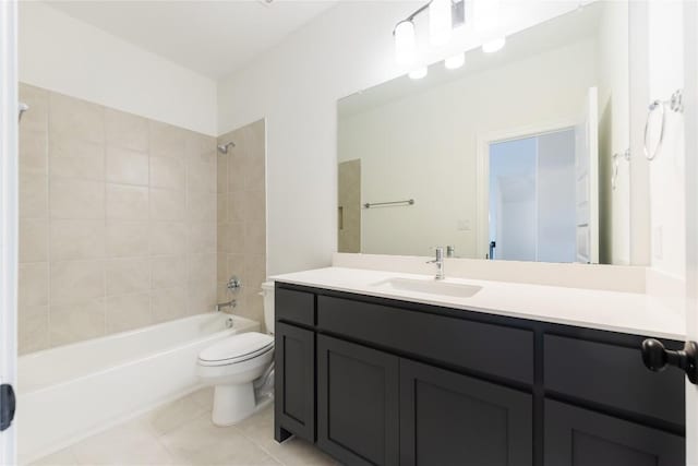 full bathroom with tile patterned flooring, vanity, toilet, and tiled shower / bath