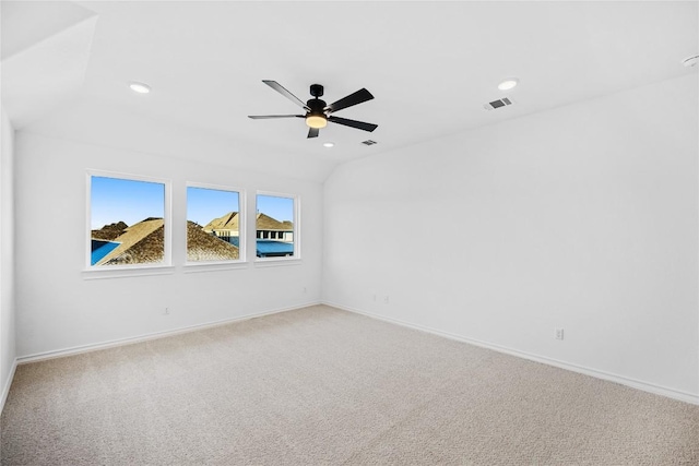 carpeted empty room featuring ceiling fan and lofted ceiling