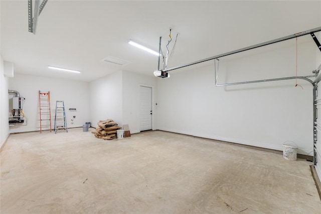 garage featuring a garage door opener and water heater