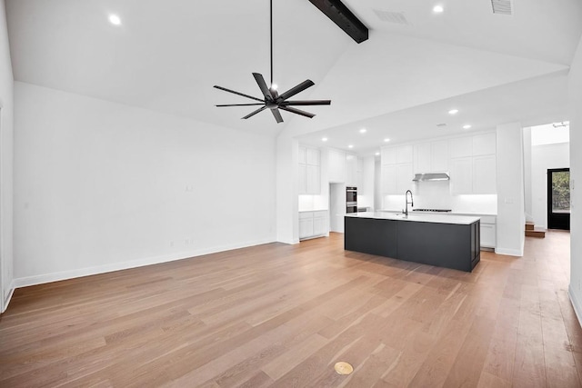 1509 Jay Wolf, Georgetown, TX 78628 - living area with high vaulted ceiling, light wood-type flooring, beamed ceiling, recessed lighting, and baseboards