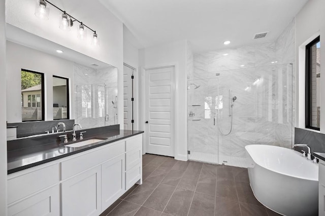 1509 Jay Wolf, Georgetown, TX 78628 - full bathroom with a marble finish shower, a freestanding bath, vanity, and recessed lighting