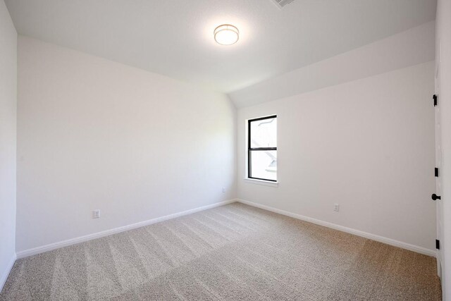 1509 Jay Wolf, Georgetown, TX 78628 - spare room with light colored carpet, baseboards, and vaulted ceiling