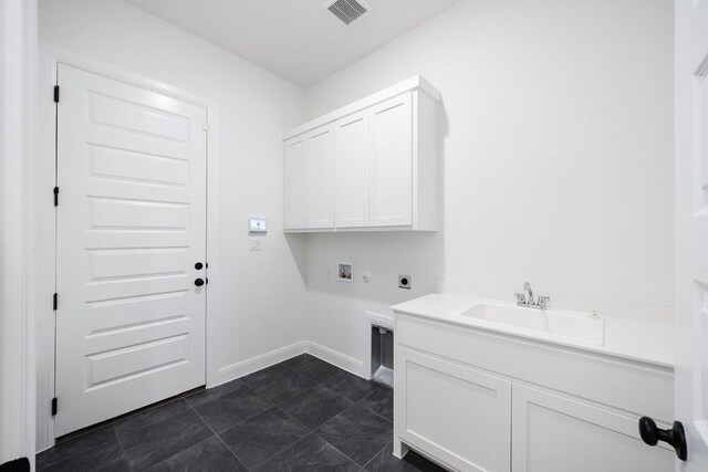 1509 Jay Wolf, Georgetown, TX 78628 - washroom featuring hookup for an electric dryer, washer hookup, cabinet space, and baseboards