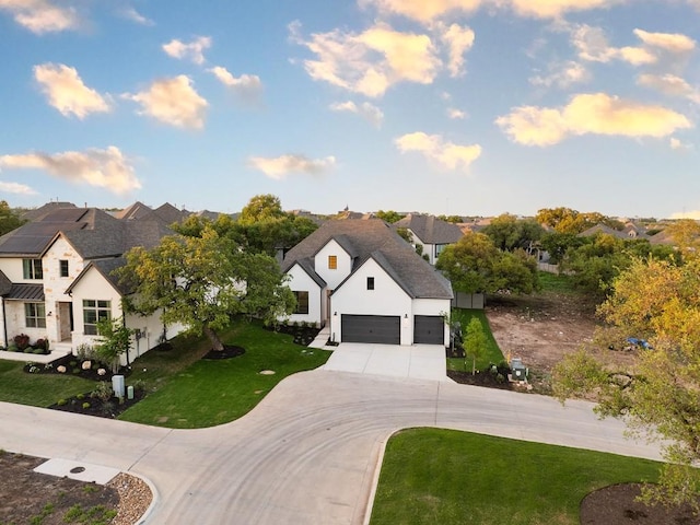 1509 Jay Wolf, Georgetown, TX 78628 - view of front of home featuring a residential view, concrete driveway, a front lawn, a garage, and stucco siding