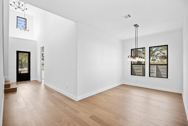 1509 Jay Wolf, Georgetown, TX 78628 - entrance foyer with a chandelier, light wood-type flooring, and baseboards
