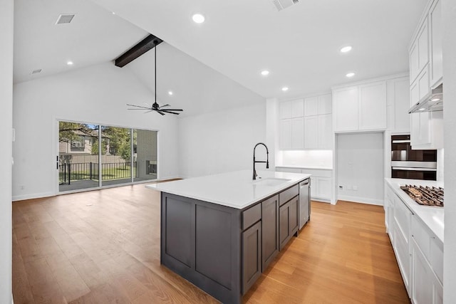 1509 Jay Wolf, Georgetown, TX 78628 - kitchen with a sink, beamed ceiling, white cabinets, stainless steel appliances, and recessed lighting