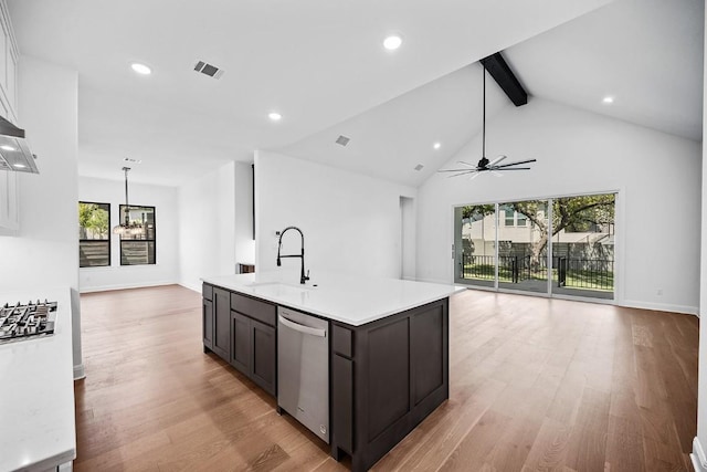 1509 Jay Wolf, Georgetown, TX 78628 - kitchen with a sink, stainless steel dishwasher, open floor plan, beamed ceiling, and light countertops