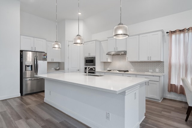 kitchen featuring white cabinets, sink, stainless steel appliances, and hanging light fixtures