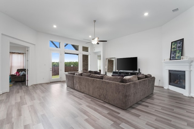 living room with ceiling fan and light wood-type flooring