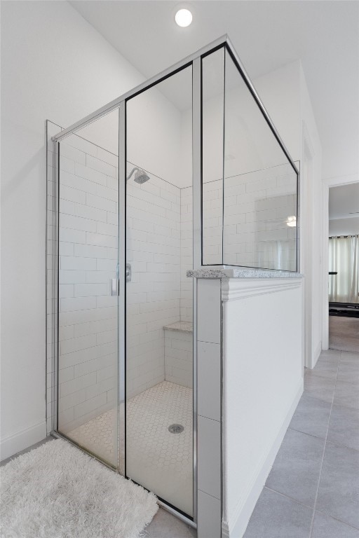 bathroom with tile patterned floors and an enclosed shower