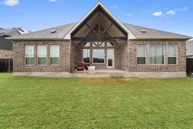 rear view of property featuring a yard and a patio