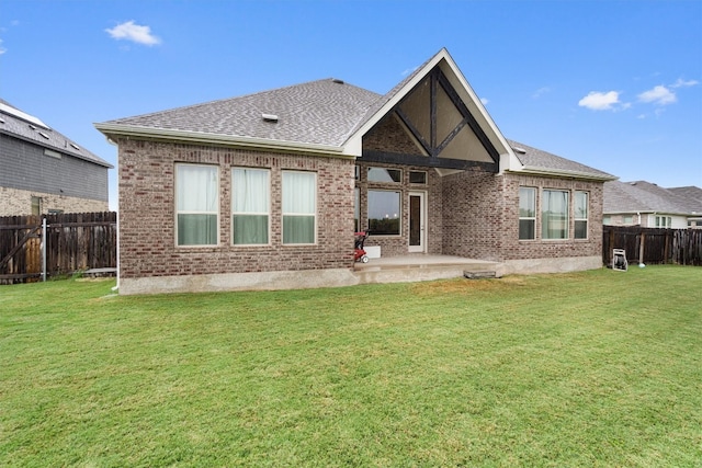 rear view of house with a patio area and a yard