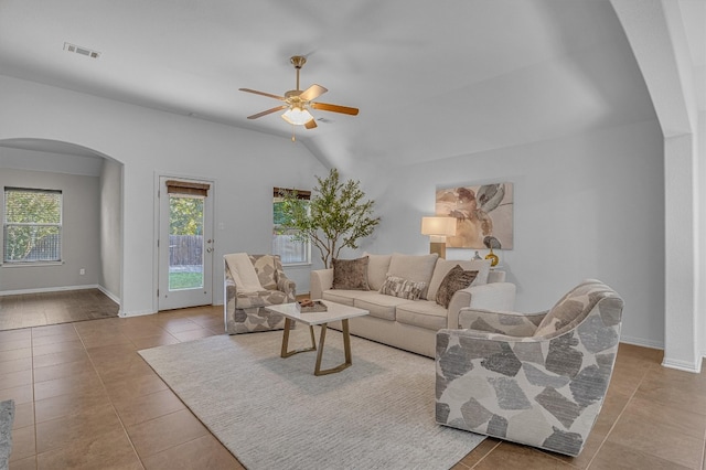 living room with light tile patterned floors, ceiling fan, and lofted ceiling