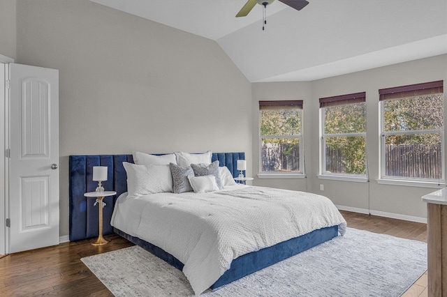 bedroom with ceiling fan, dark hardwood / wood-style floors, and vaulted ceiling