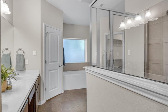 bathroom with shower with separate bathtub, vanity, and tile patterned floors