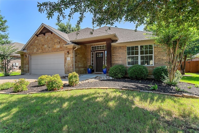 single story home featuring a garage and a front lawn