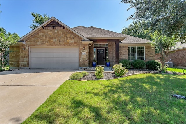 view of front of house featuring a front lawn and a garage