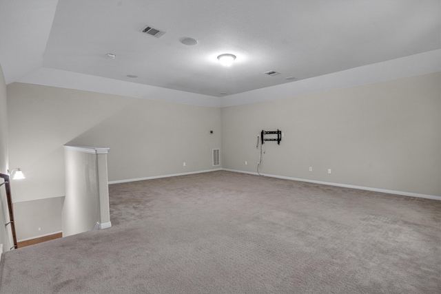 carpeted spare room with lofted ceiling