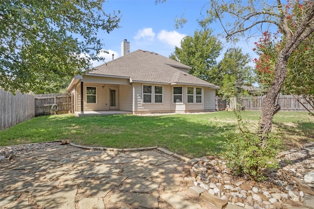 rear view of house featuring a yard and a patio area