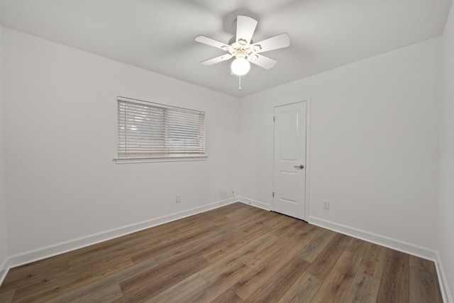 spare room featuring ceiling fan and dark hardwood / wood-style flooring