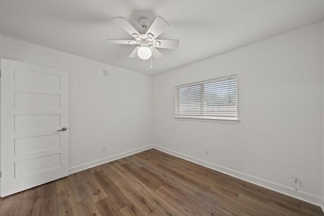 spare room featuring ceiling fan and dark hardwood / wood-style floors