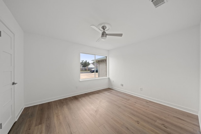 empty room with hardwood / wood-style flooring and ceiling fan