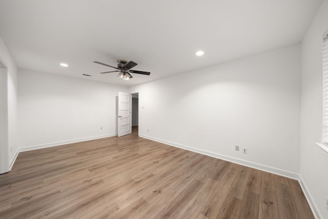 spare room with ceiling fan and light wood-type flooring