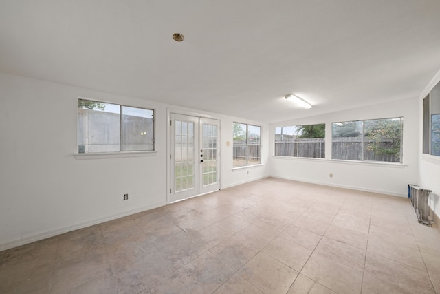 unfurnished sunroom featuring french doors and lofted ceiling