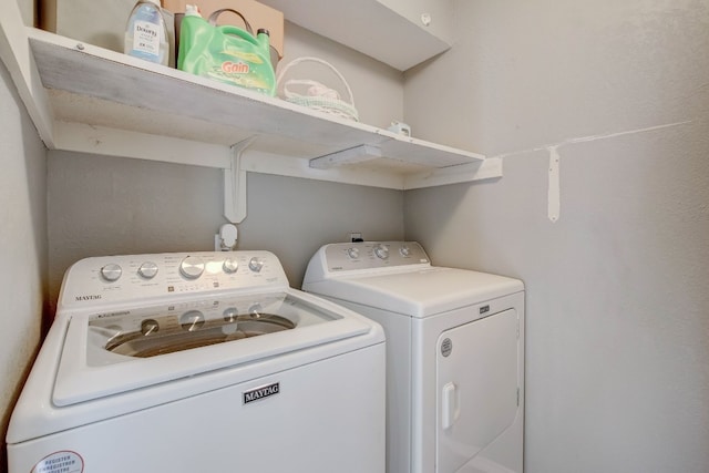 washroom with washing machine and clothes dryer