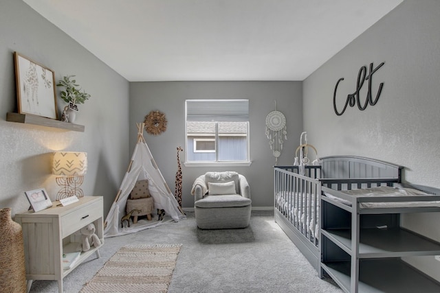 bedroom featuring carpet and a crib