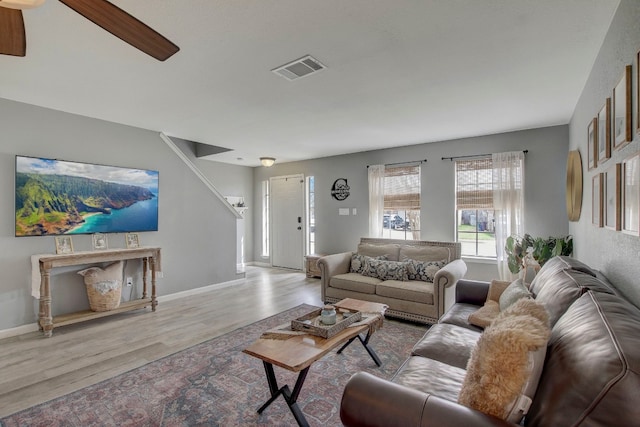 living room featuring light hardwood / wood-style floors and ceiling fan