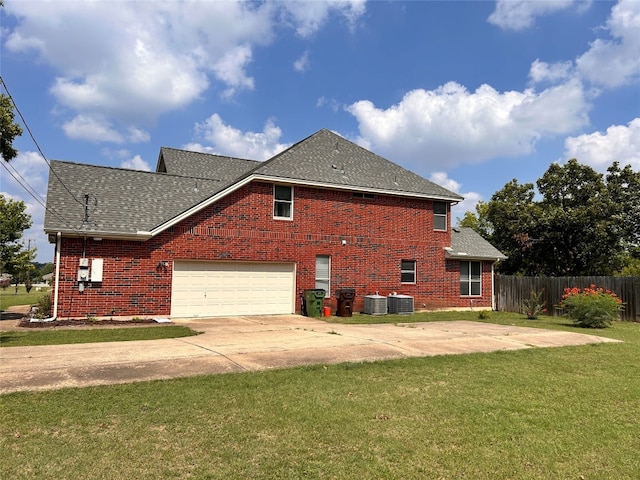 view of home's exterior featuring a yard, a garage, and central air condition unit