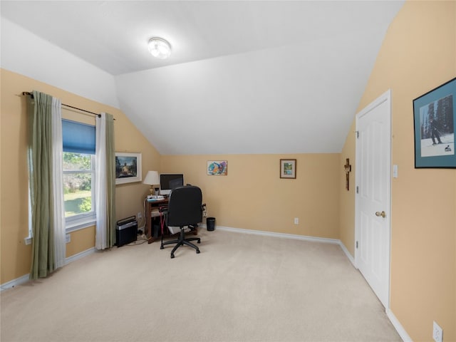 carpeted office space featuring vaulted ceiling