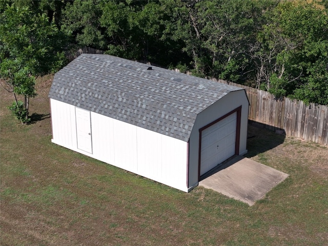 view of outbuilding featuring a garage and a lawn