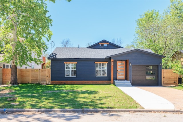 view of front of home with a front lawn and a garage