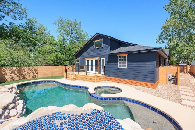 view of pool with an in ground hot tub and french doors