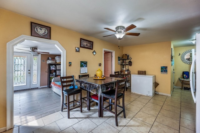 tiled dining area featuring ceiling fan